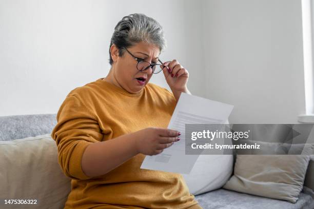 woman worried about bills - fees stock pictures, royalty-free photos & images