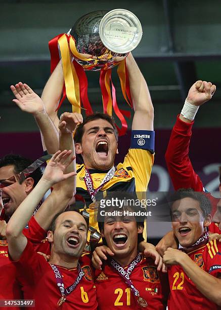 Captain Iker Casillas of Spain lifts the trophy after victory during the UEFA EURO 2012 final match between Spain and Italy at the Olympic Stadium on...