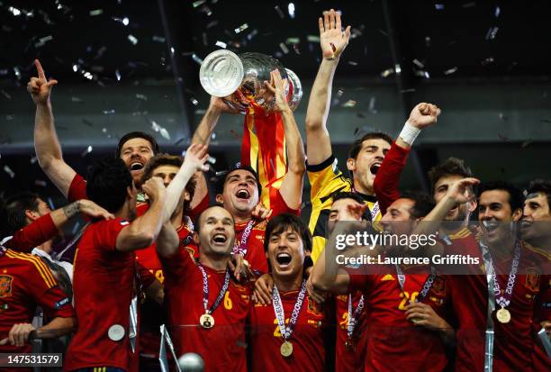 Xavi Hernandez of Spain lifts the trophy as he celebrates with team-mates following victory in the UEFA EURO 2012 final match between Spain and Italy...