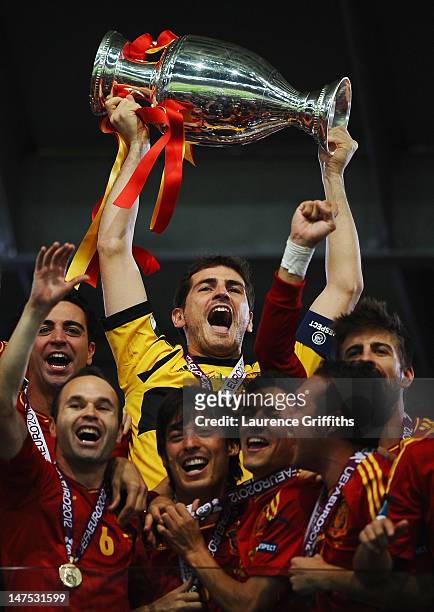 Iker Casillas of Spain lifts the trophy as he celebrates following victory in the UEFA EURO 2012 final match between Spain and Italy at the Olympic...