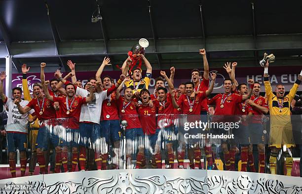 Captain Iker Casillas of Spain lifts the trophy after victory during the UEFA EURO 2012 final match between Spain and Italy at the Olympic Stadium on...