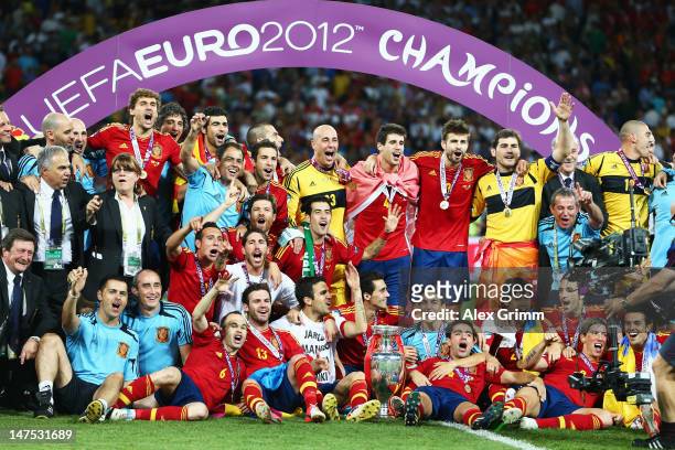 Spain players and coaching staff celebrate with the trophy following victory in the UEFA EURO 2012 final match between Spain and Italy at the Olympic...