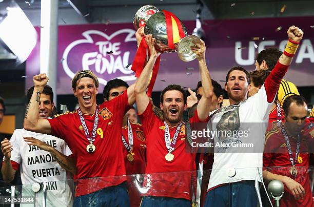 Goalscorers Fernando Torres and Juan Mata of Spain hold the trophy next to team-mates Cesc Fabregas and Sergio Ramos during the UEFA EURO 2012 final...