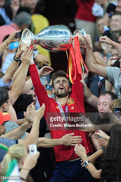 Gerard Pique of Spain celebrates with the trophy after victory during the UEFA EURO 2012 final match between Spain and Italy at the Olympic Stadium...