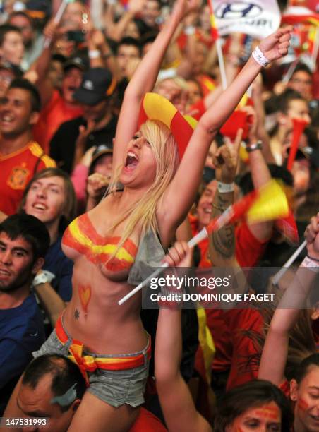 Supporters of the Spanish national football team celebrate on July 1, 2012 in Madrid after their team won the final match of the Euro 2012 football...