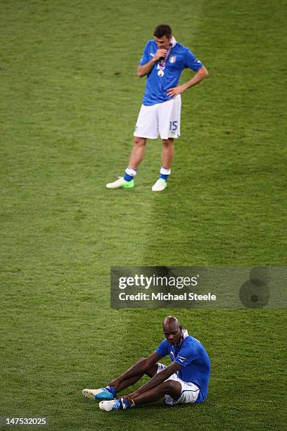 Mario Balotelli of Italy and Andrea Barzagli of Italy show their dejection after their defeat during the UEFA EURO 2012 final match between Spain and...