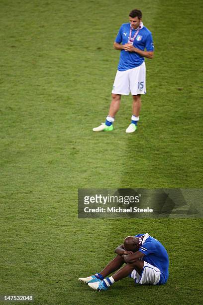 Mario Balotelli of Italy and Andrea Barzagli of Italy show their dejection after their defeat during the UEFA EURO 2012 final match between Spain and...