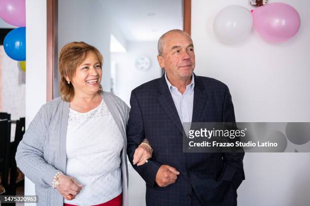 senior couple talking on the party at home - the party arrivals stock pictures, royalty-free photos & images