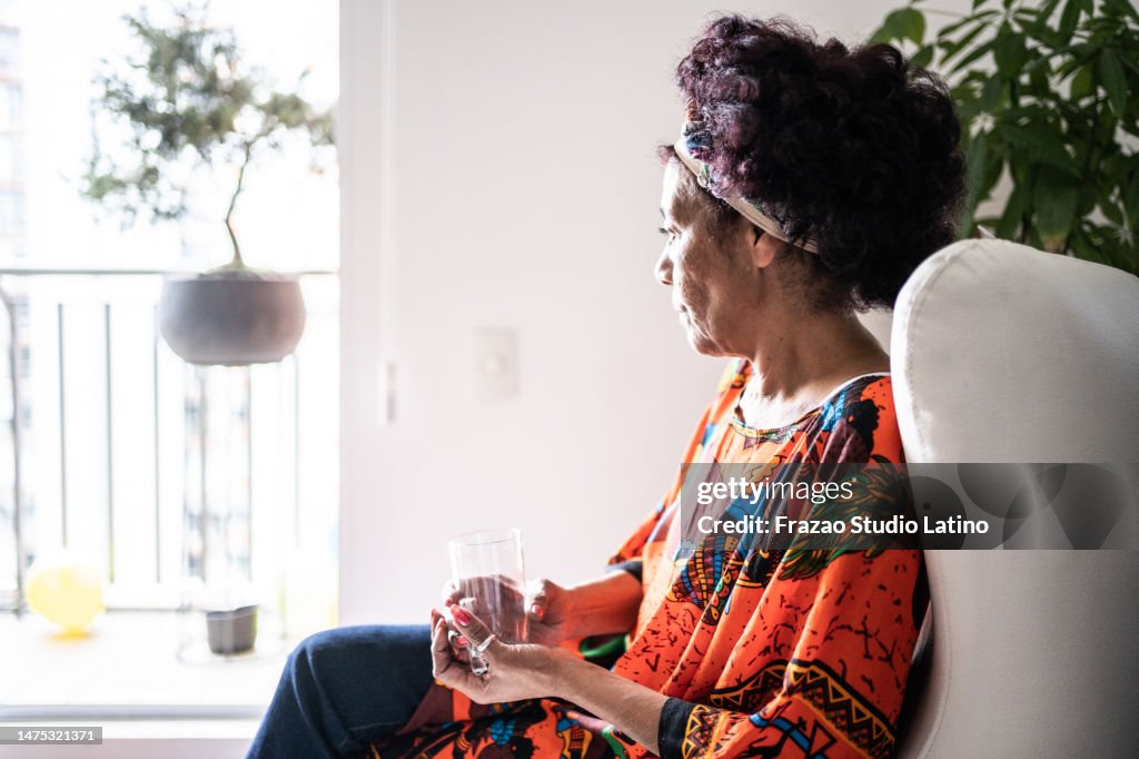 Senior woman looking away contemplating at home