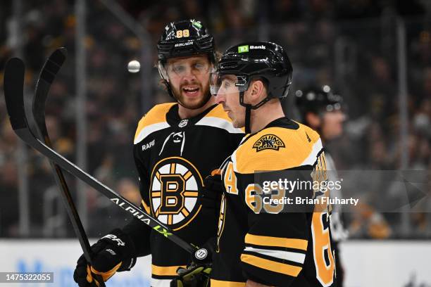 David Pastrnak of the Boston Bruins talks with Brad Marchand during the first period of a game against the Ottawa Senators at the TD Garden on March...