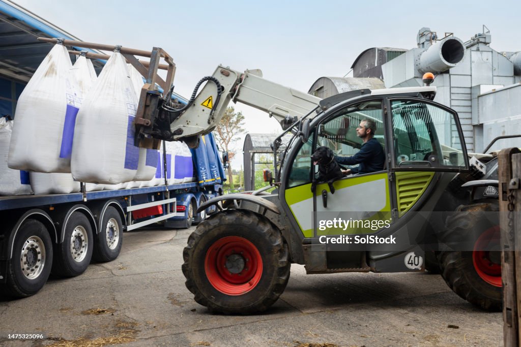 Farmer Receiving A Delivery Of Nitrogen Sulphur Fertiliser To A Sustainable Farm.