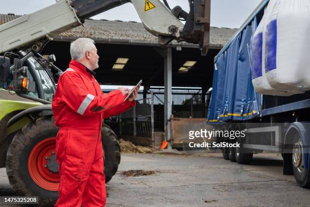 farmer receiving a delivery of nitrogen sulphur fertiliser. - integrity stock pictures, royalty-free photos & images