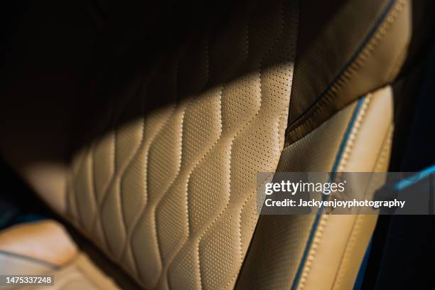 full frame shot of brown leathet car seat - automobile di lusso foto e immagini stock