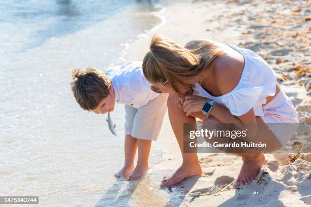 mom and son enjoying the beach - playa del carmen beach stock pictures, royalty-free photos & images