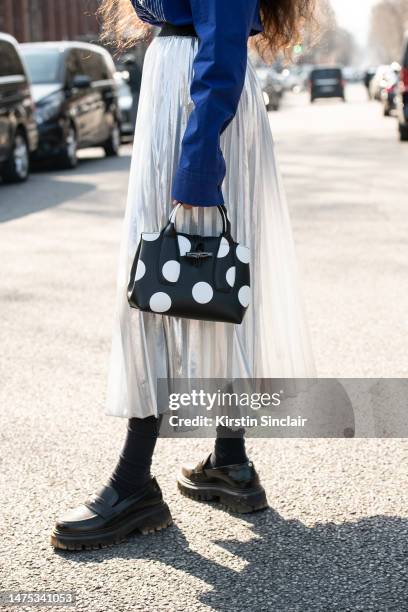 Ciinderella Balthazar wears an Off White shirt, Maje skirt and shoes and a Longchamp bag outside the Off White show on March 02, 2023 in Paris,...