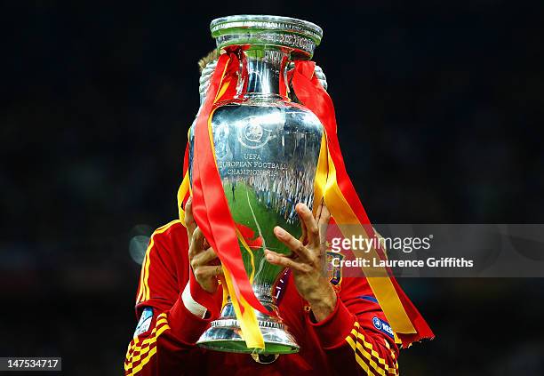 Gerard Pique of Spain kisses the trophy following victory in the UEFA EURO 2012 final match between Spain and Italy at the Olympic Stadium on July 1,...