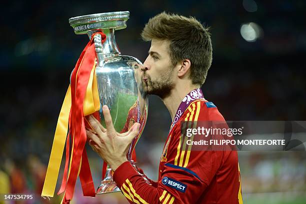 Spanish defender Gerard Pique kisses the trophy after winning the Euro 2012 football championships final match Spain vs Italy on July 1, 2012 at the...