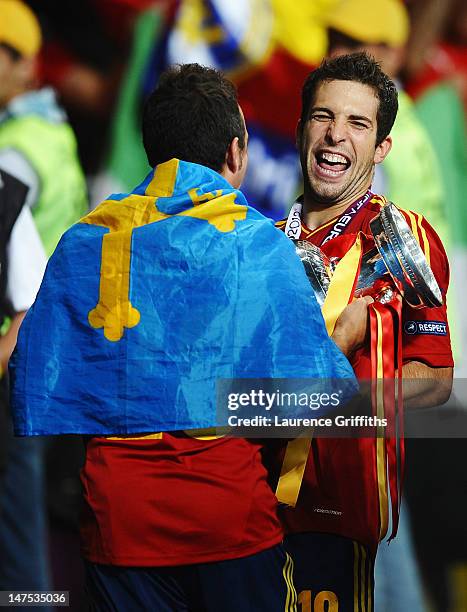 Jordi Alba and Santi Cazorla of Spain celebrate with the trophy following their team's victory during the UEFA EURO 2012 final match between Spain...