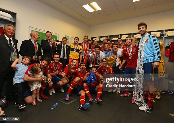 Spanish president Mariano Rajoy and Prince Felipe of Spain pose with the Spain team in the dressing room and following the UEFA EURO 2012 final match...