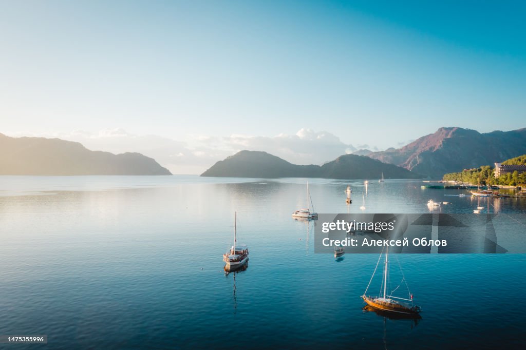 Morning in the bay of Marmaris. Soft dawn. Yachts and boats in the bay of the Mediterranean Sea. Turkish landscape