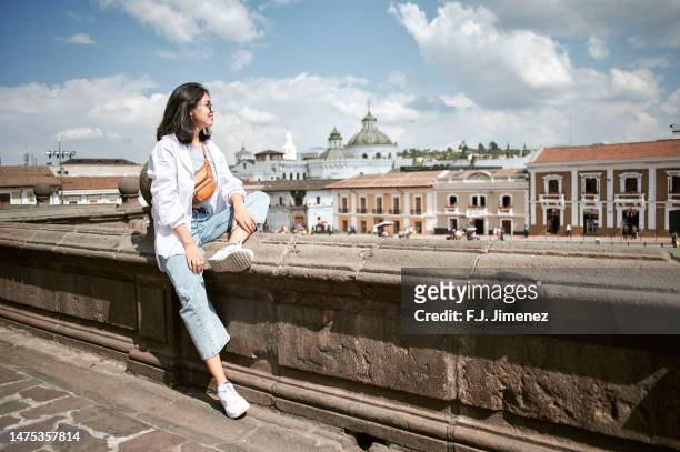 woman sitting in the square of san francisco de quito, ecuador - quito stock pictures, royalty-free photos & images