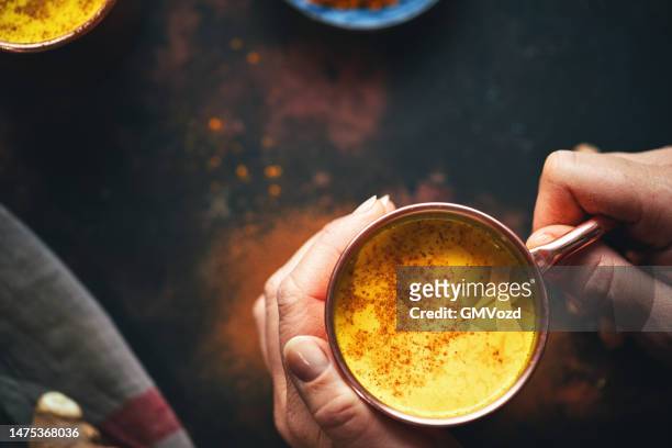 healthy golden milk with turmeric - ayurveda stock pictures, royalty-free photos & images