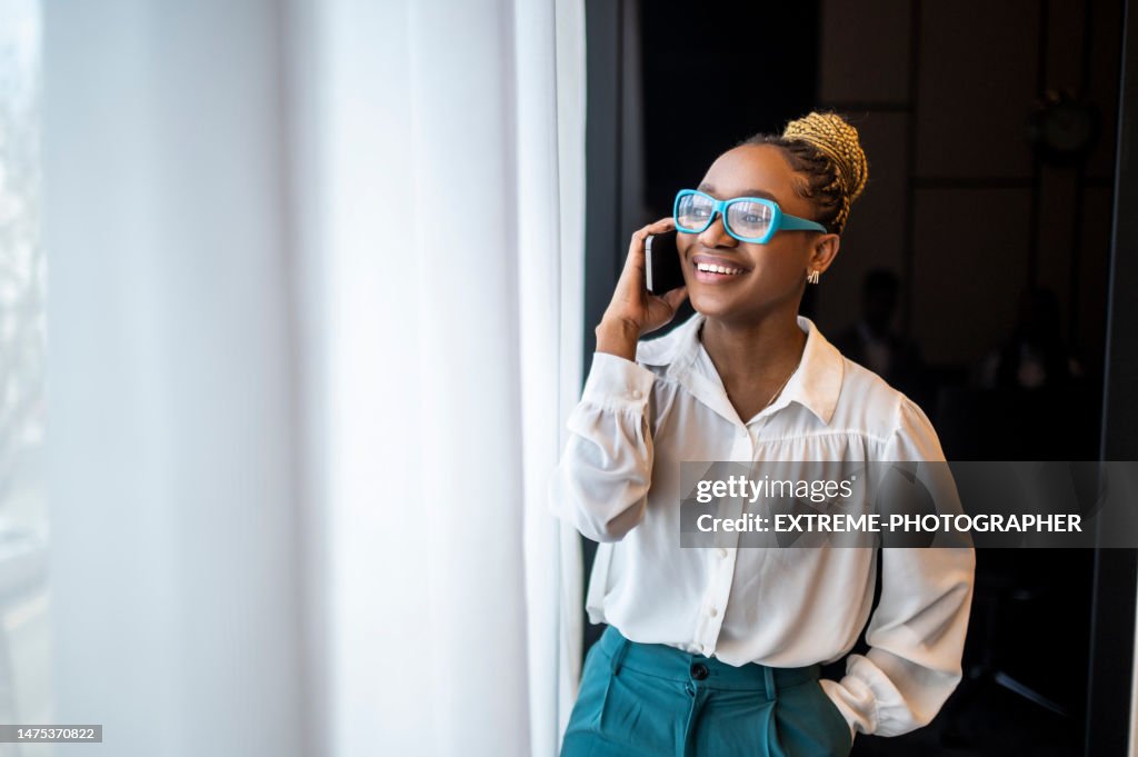 Portrait of a smiling black female entrepreneur talking on the phone