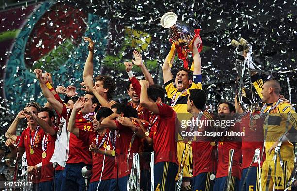 Iker Casillas of Spain lifts the trophy as he celebrates following victory in the UEFA EURO 2012 final match between Spain and Italy at the Olympic...