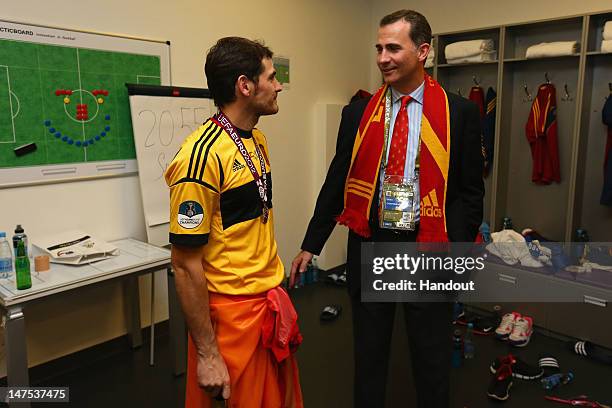 Prince Felipe of Spain speaks to Iker Casillas of Spain in the dressing room following the UEFA EURO 2012 final match between Spain and Italy at the...