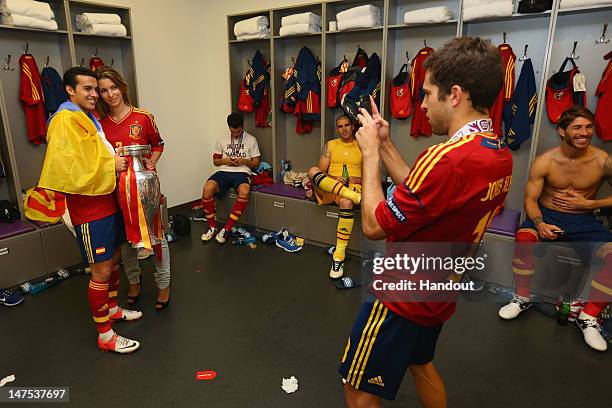 Pedro of Spain poses with the trophy in the dressing room following the UEFA EURO 2012 final match between Spain and Italy at the Olympic Stadium on...