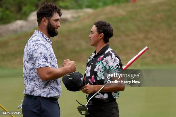 Jon Rahm of Spain and Rickie Fowler of the United States shake hands on the 17th green after Fowler won their match 2 & 1 during day one of the World...