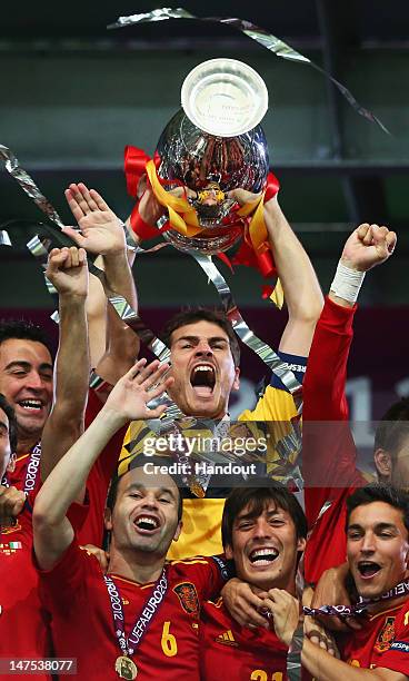 Captain Iker Casillas of Spain lifts the trophy after victory during the UEFA EURO 2012 final match between Spain and Italy at the Olympic Stadium on...