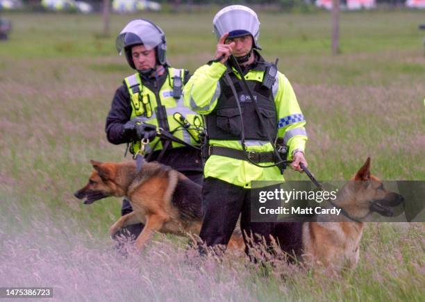 Police dog handlers gesture during disturbances at the secure fence at the G8 summit on July 6, 2005 near Gleneagles, Scotland. The 31st G8 summit...