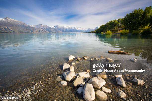 blue river with mountain in background. - lake tekapo ストックフォトと画像