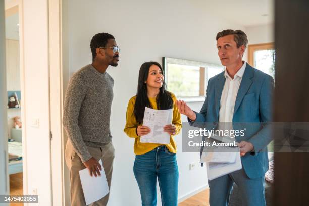 future house owners indoors doing a visit with a real estate agent - real estate agents stock pictures, royalty-free photos & images