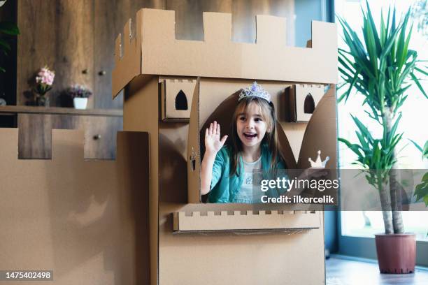 cute little princess playing role play game at home with castle made of cardboard - princess castle stock pictures, royalty-free photos & images