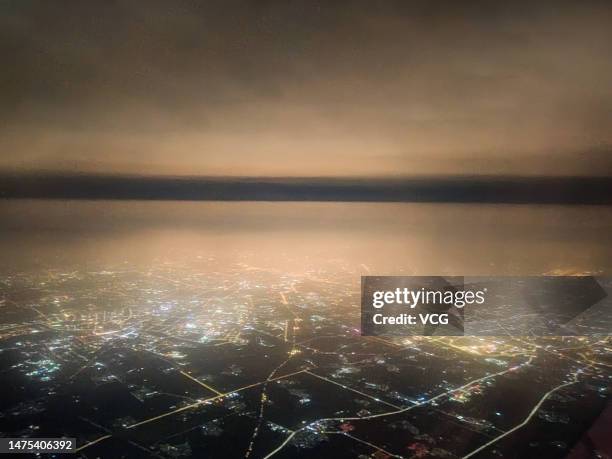 Sand and dust silhouette city skyline as a sandstorm engulfs buildings on March 22, 2023 in Beijing, China. Beijing's Meteorological Observatory...