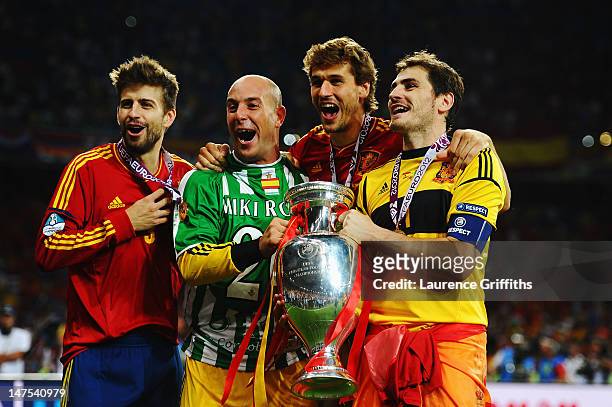 Gerard Pique, Pepe Reina, Fernando Llorente and Iker Casillas of Spain celebrate with the trophy following victory in the UEFA EURO 2012 final match...