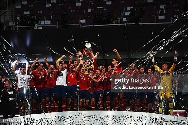 Iker Casillas of Spain lifts the trophy as he celebrates following victory in the UEFA EURO 2012 final match between Spain and Italy at the Olympic...