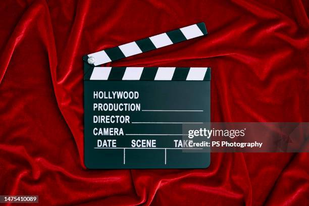 clapperboard on red satin background, copy space. - clapperboard stock pictures, royalty-free photos & images