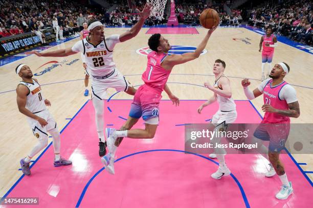 Johnny Davis of the Washington Wizards puts up a shot against Zeke Nnaji of the Denver Nuggets during the first half at Capital One Arena on March...