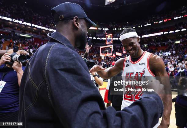 Dwyane Wade and Jimmy Butler of the Miami Heat meet on the court after a game between the Miami Heat and New York Knicks at Miami-Dade Arena on March...