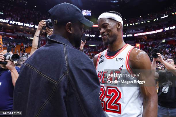 Dwyane Wade and Jimmy Butler of the Miami Heat meet on the court after a game between the Miami Heat and New York Knicks at Miami-Dade Arena on March...