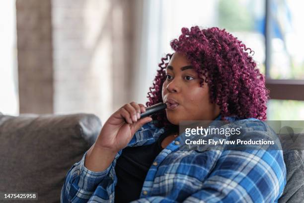 woman at home vaping - electronic cigarette stock pictures, royalty-free photos & images