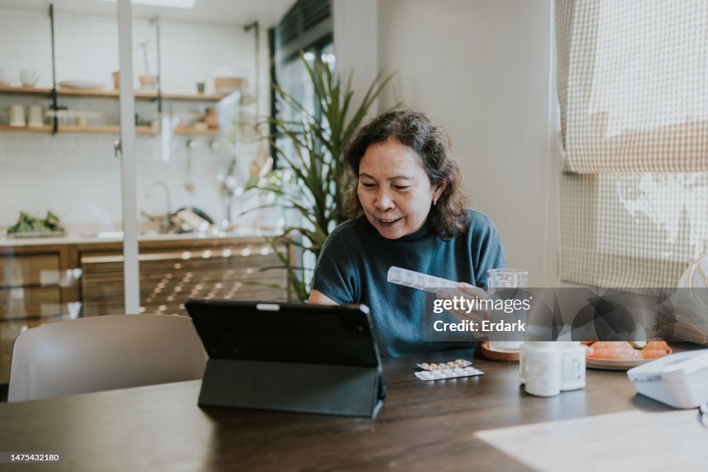 Telemedicine of senior woman consulting with her doctor on video conference.