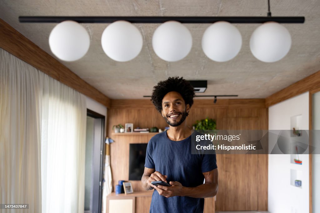 Man controlling a lamp in her house using an automated system