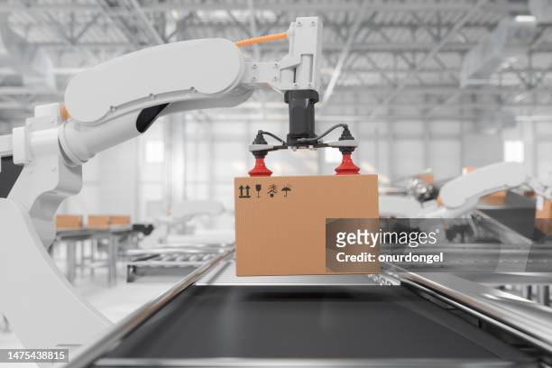 side view of robotic arm carrying carton box on conveyor belt in smart distribution warehouse - robotic arm factory stock pictures, royalty-free photos & images
