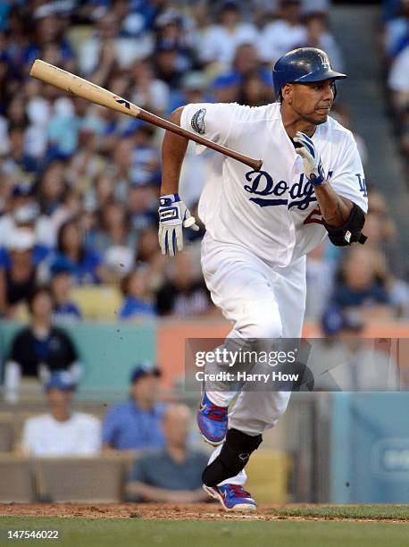 Juan Rivera of the Los Angeles Dodgers hits into a fileder's choice scoring two runs after an error by Mike Nickeas of the New York Mets during the...