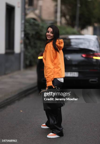 Tara Tut seen wearing an orange Christian Dior hoodie, Copenhagen Studios x The Wants orange and white sneaker, Hermes black bag and Hermes orange...