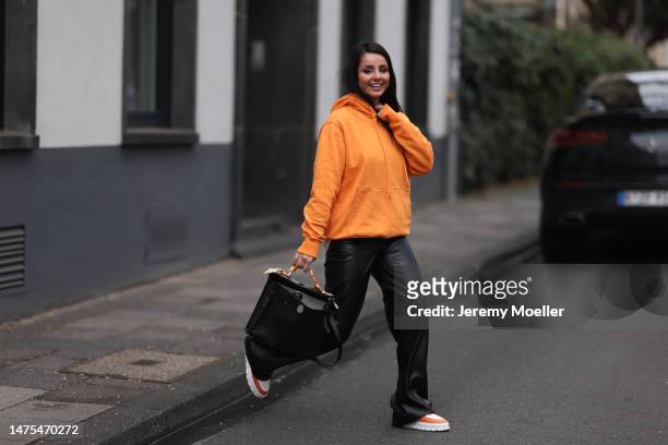 Tara Tut seen wearing an orange Christian Dior hoodie, Copenhagen Studios x The Wants orange and white sneaker, Hermes black bag and Hermes orange...